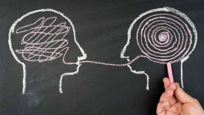 two chalk heads in profile facing one another
